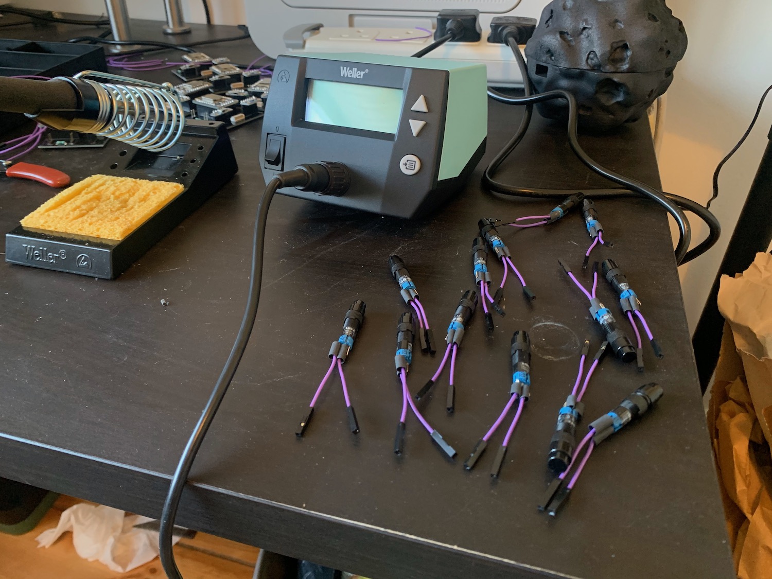 Lots of buttons with jumper wires attached on a desk