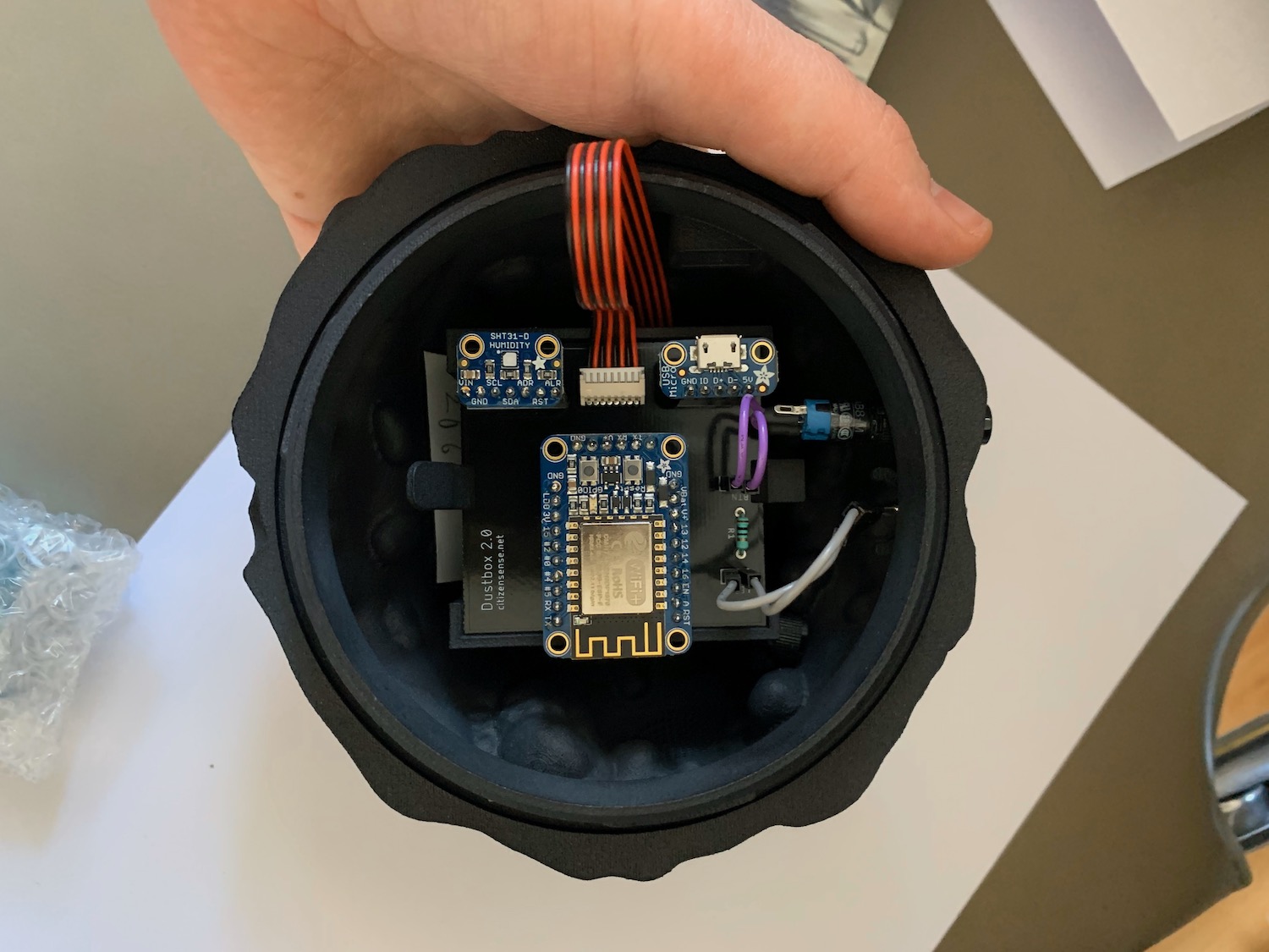 The bottom of the diesel char Dustbox 2.0 enclosure with button, LED, sensor and PCB attached
